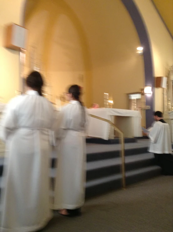 three priests, one wearing black and one in white