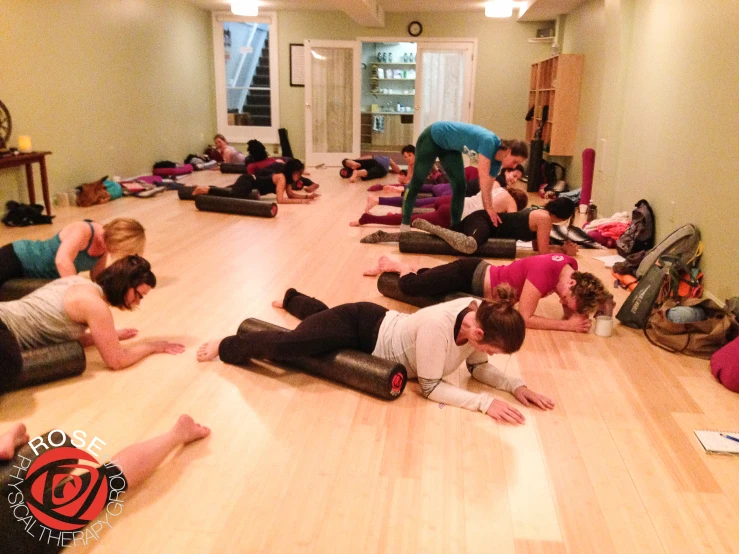 a group of people stretching in a room