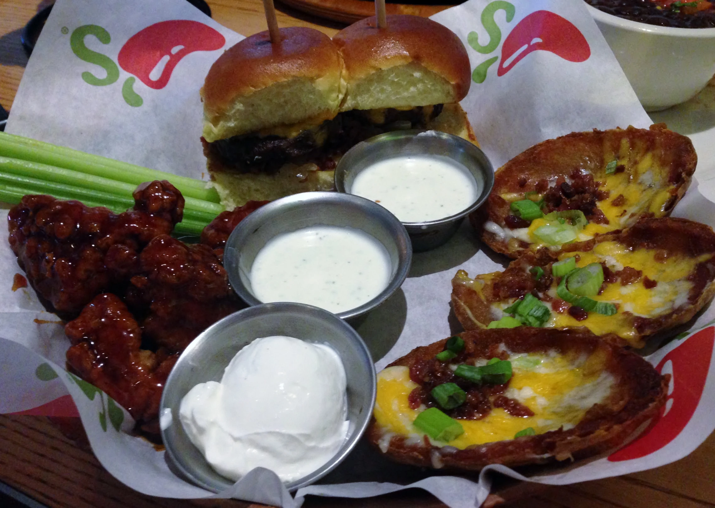 a plate with a hamburger, some other food