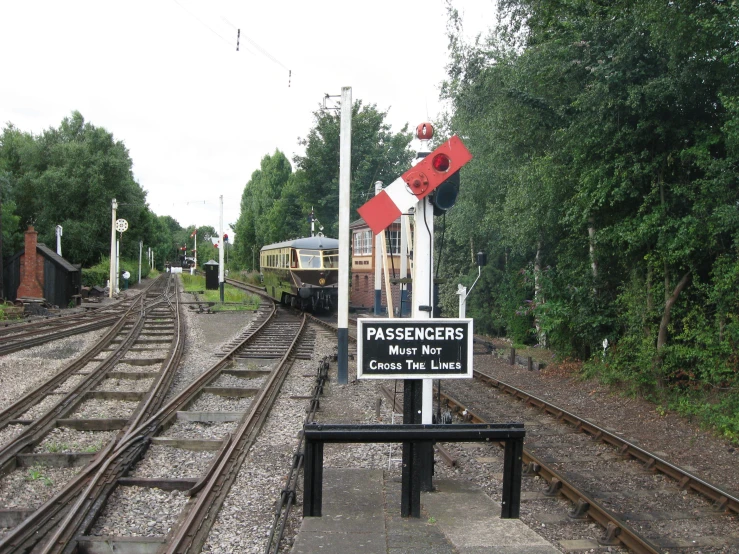 a train yard with a train and a sign