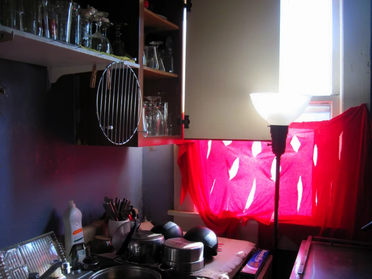 a kitchen with pots, pans and dishes on the counter