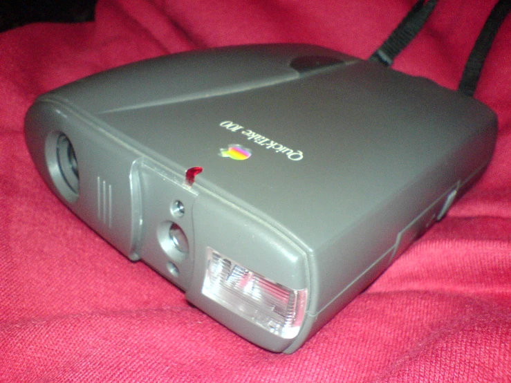 a video camera with red carpet and black straps