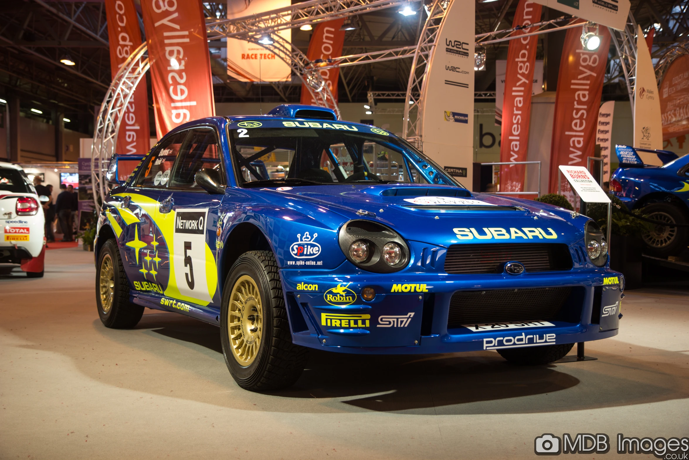 a blue subarun racing car on display at a car show