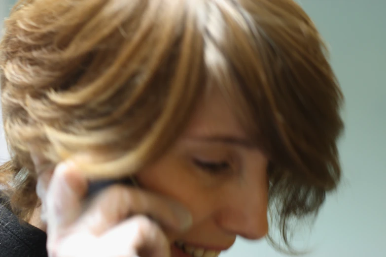 a woman talking on her cell phone smiling