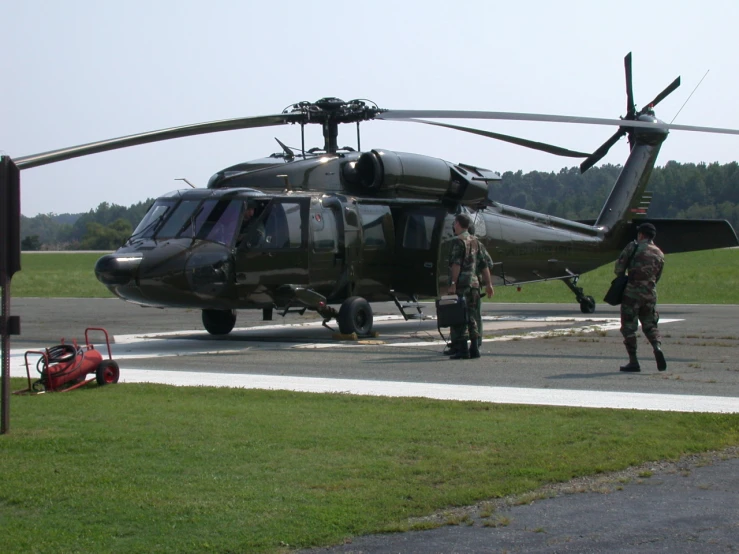 a close up of a military helicopter on a runway