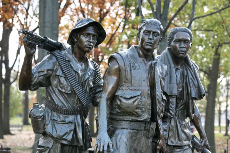a group of metal statues of men with guns