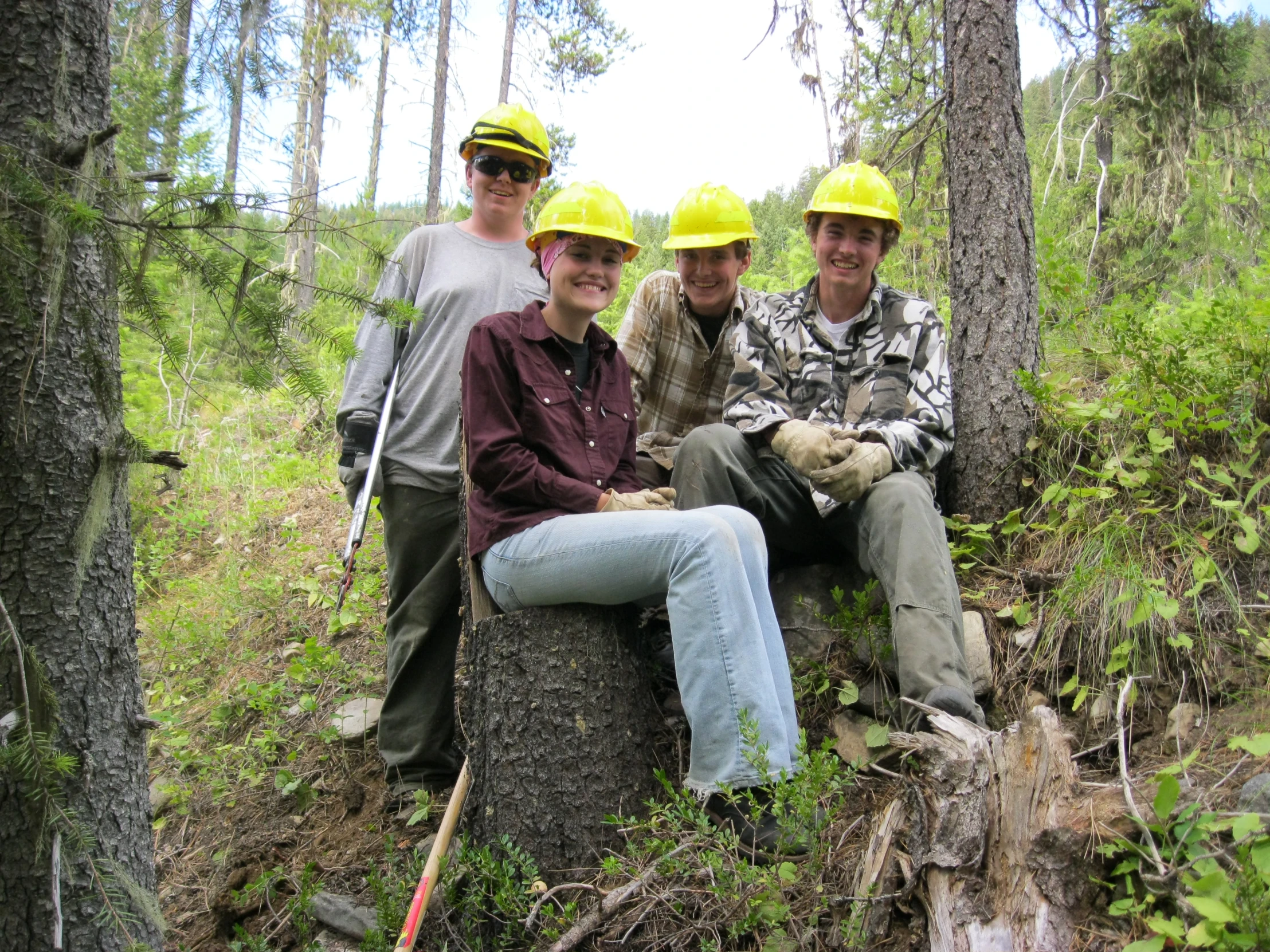 four people in the woods posing for a po