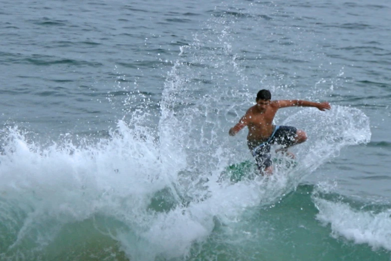 the person is riding on his surf board