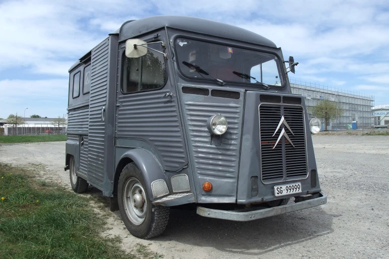 an old military truck parked in an area with grass