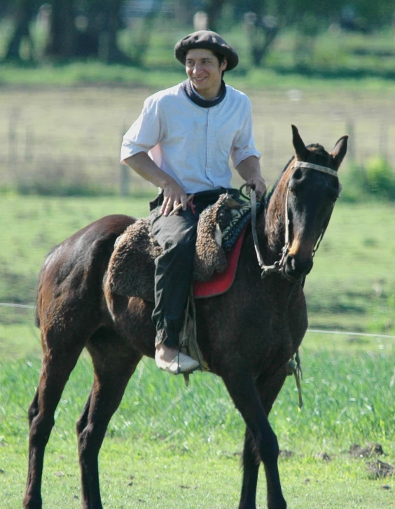 a man is riding a horse through a field