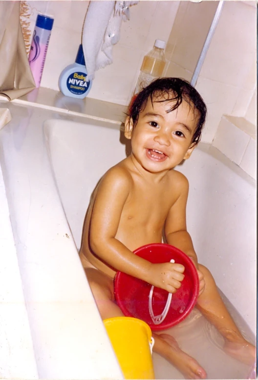 a  baby is sitting in a tub