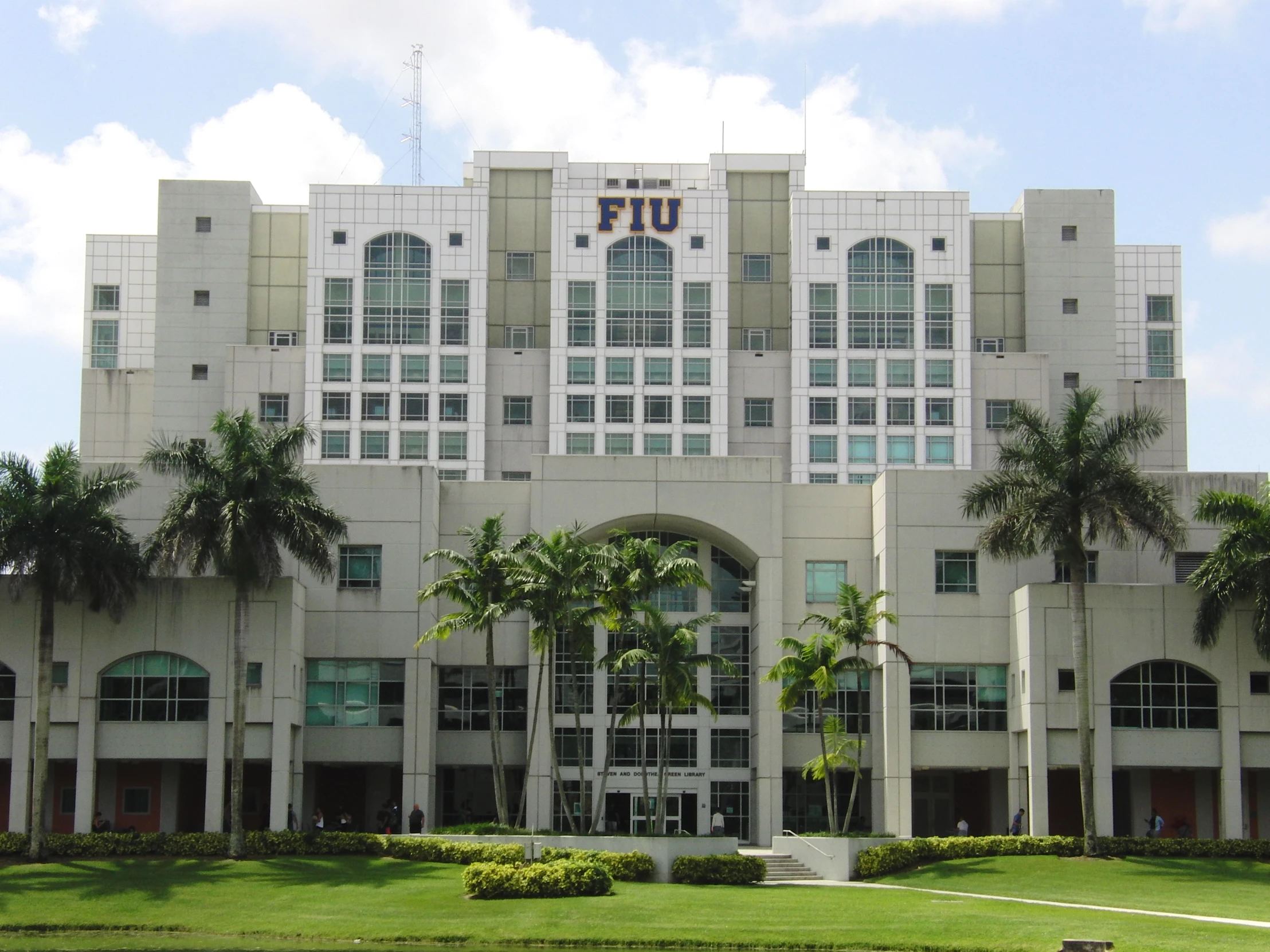 the large building is situated between palm trees