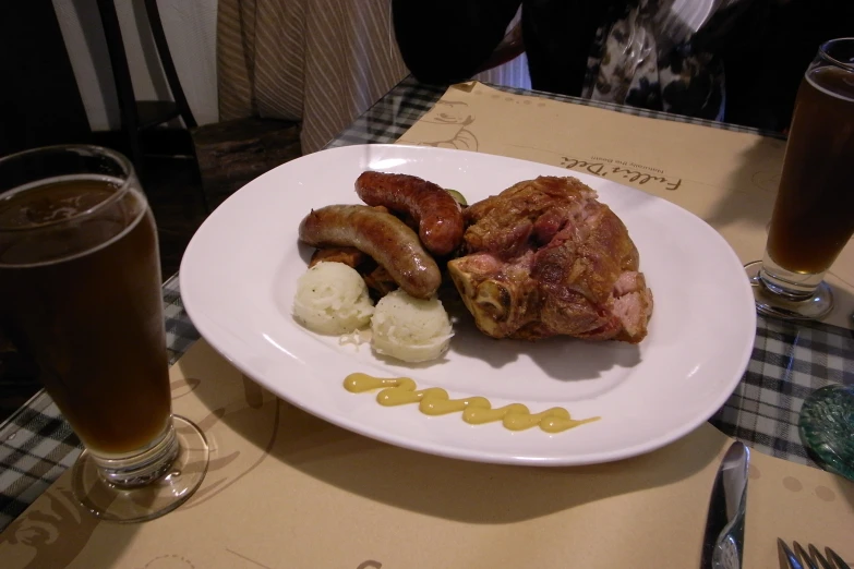 food is served on the plate next to two glasses