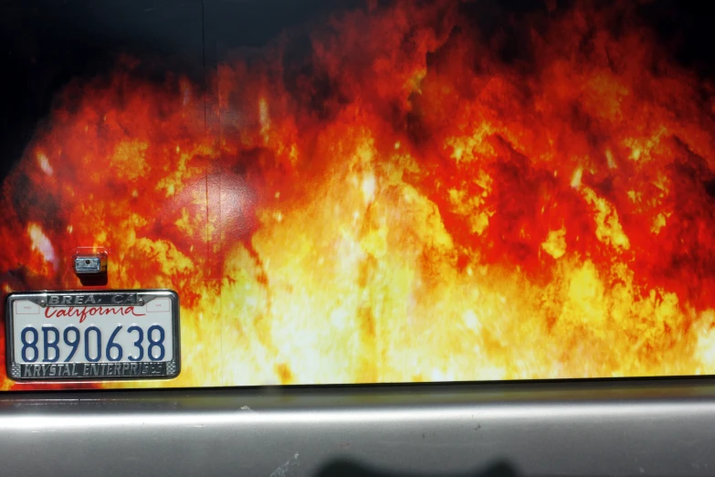 fire and orange flames in the background with license plate