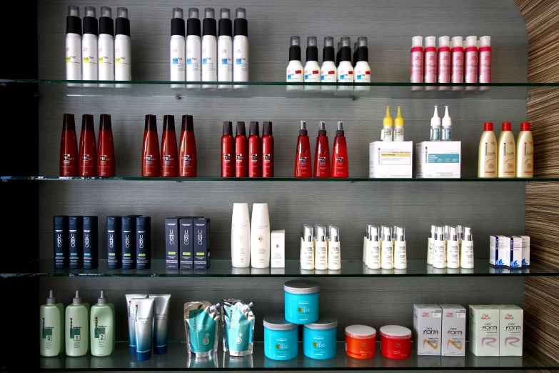 many different shades of bottles in a display case