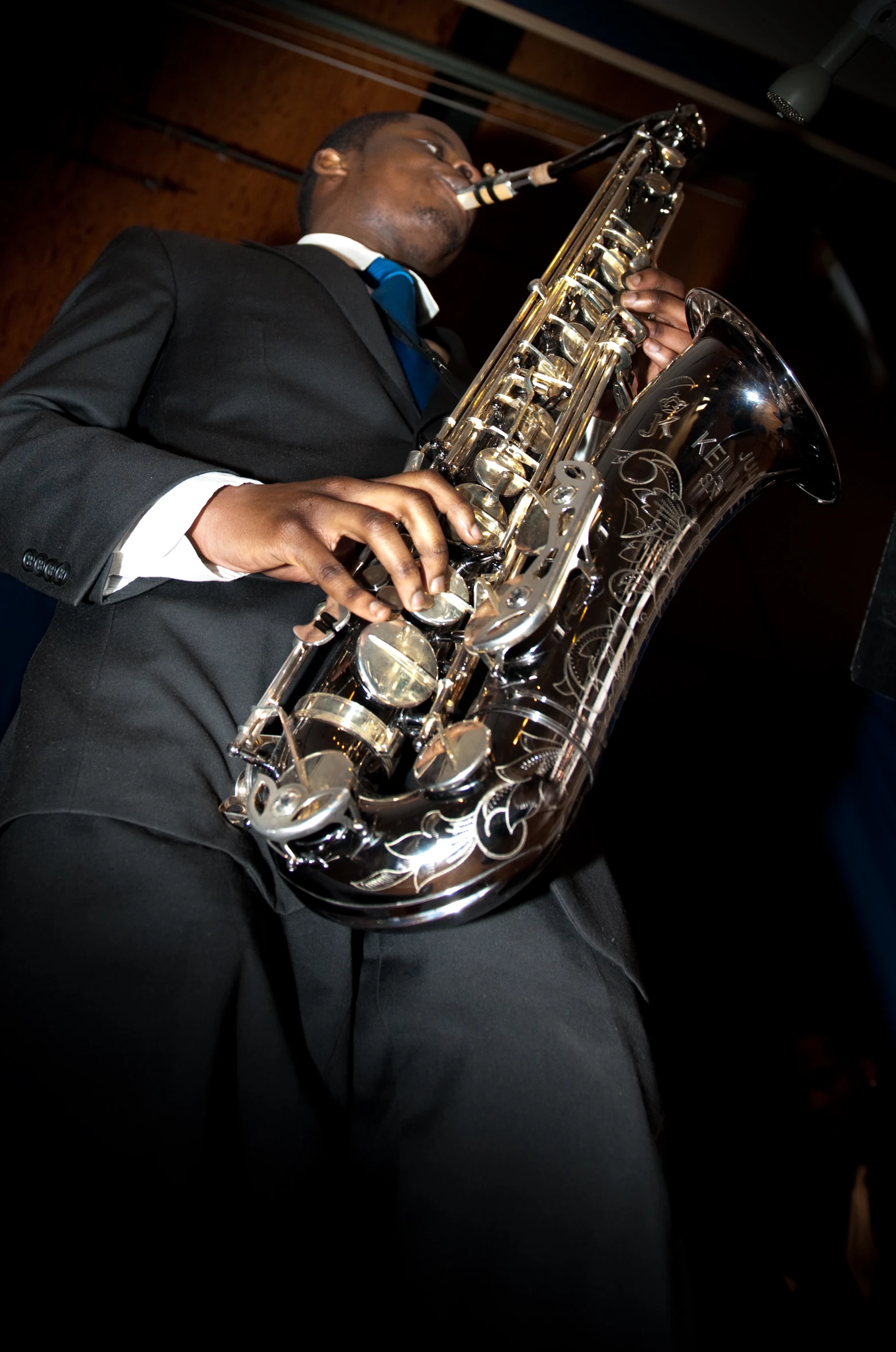 a man in a suit playing a saxophone