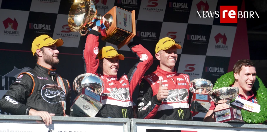 three men are holding up their trophies on top of a podium