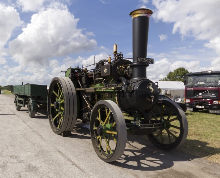 an old steam engine parked in a grass field