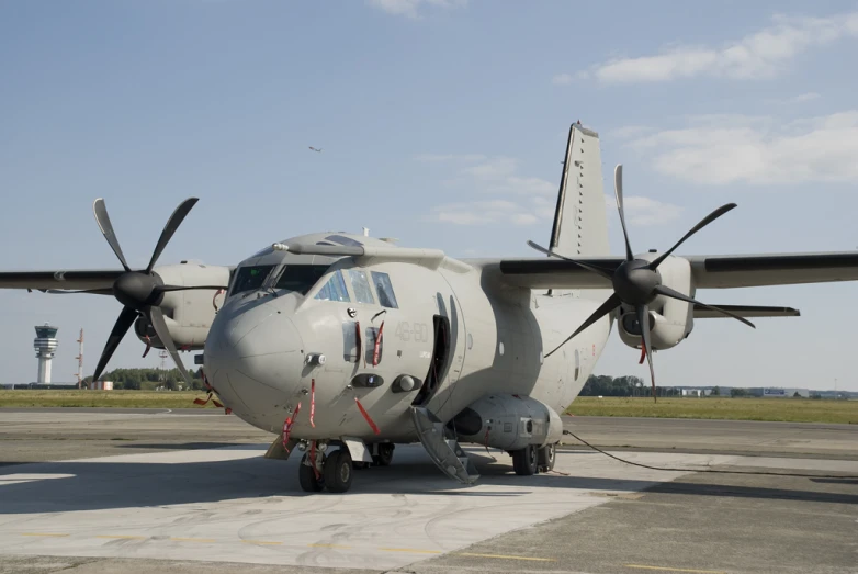 a propeller airplane is parked on the tarmac