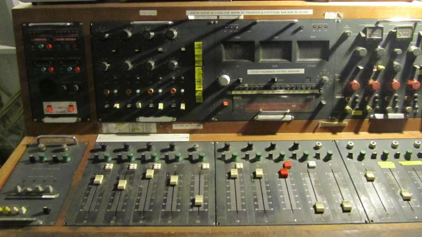 two sound mixing machines on a desk in front of a keyboard