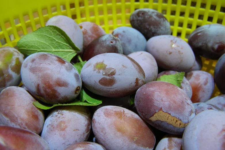 a large yellow basket filled with some fresh fruit