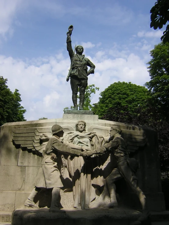 a statue of a man is holding his hands up