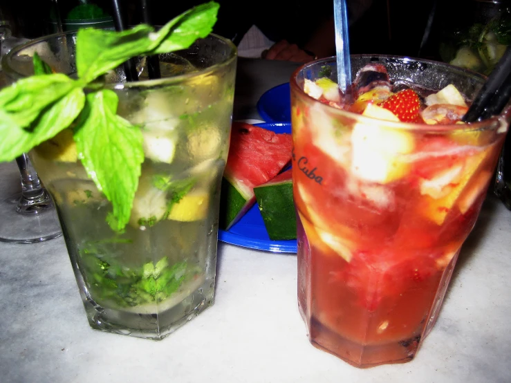 two glass filled with different flavored beverages