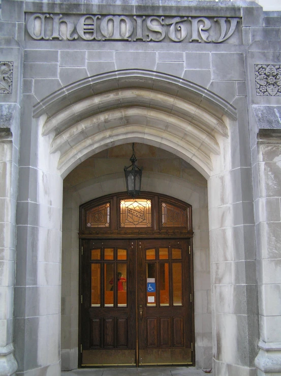 a very big pretty wooden doorway with a clock in it