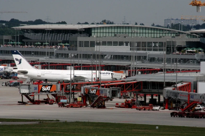 airplanes and cars are lined up at an airport