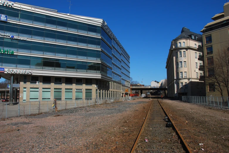 an old railroad track leads to a vacant train station