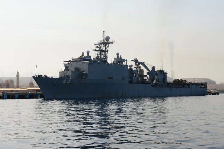 a large ship floating near a dock in a body of water