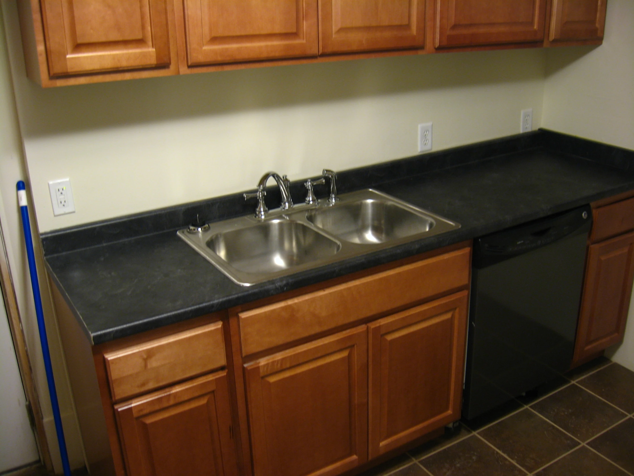 this is an image of a kitchen with a double sink and dishwasher