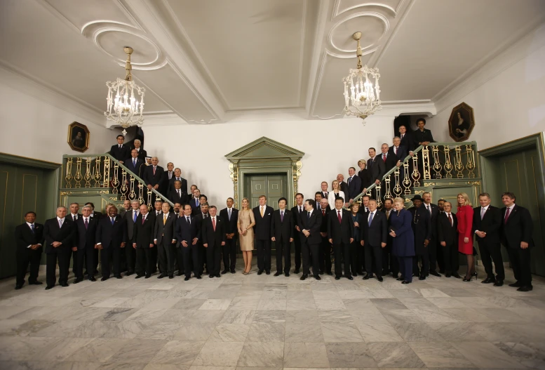 a group of people in suits posing in a hall