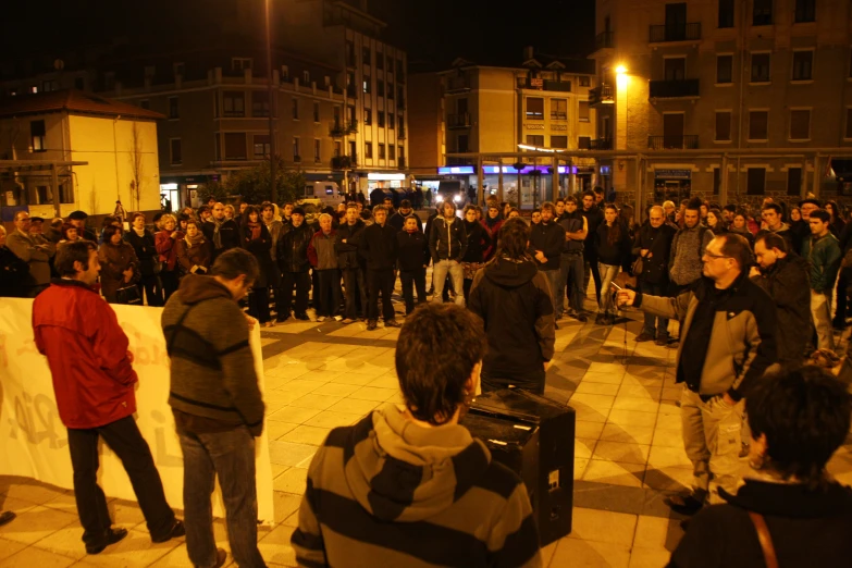 a large group of people gather in the center of the town