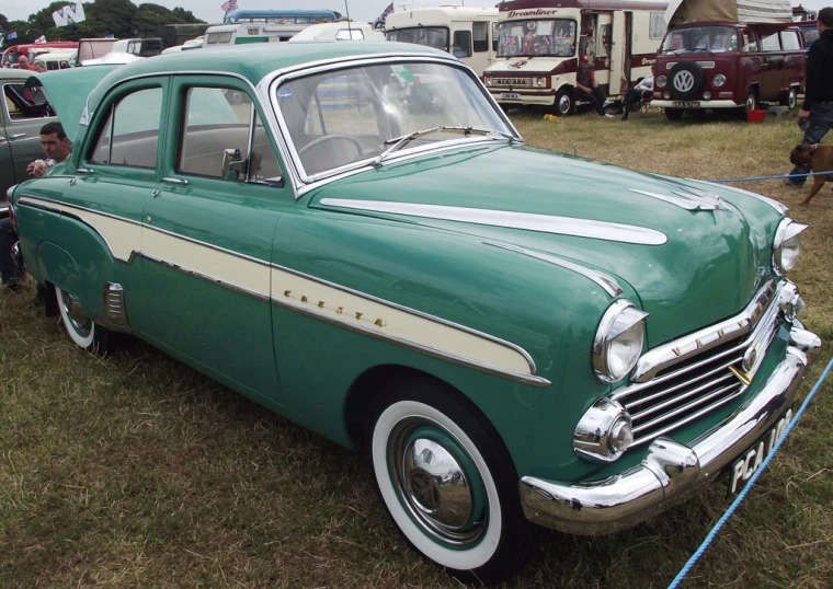 a classic car in a grassy field parked