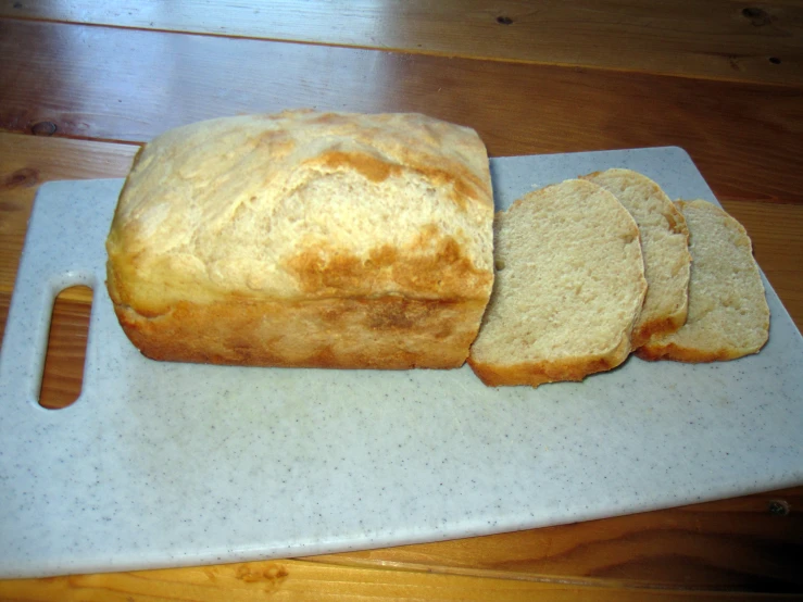 several pieces of bread are sitting on a white board