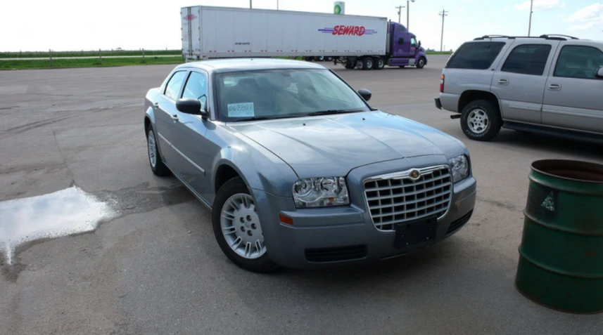 a silver car in a parking lot next to other vehicles