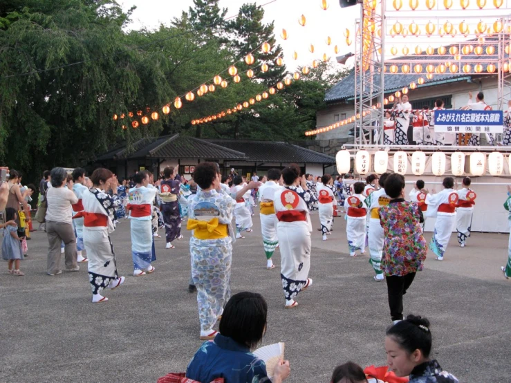 several people in colorful clothing are performing a traditional korean dance