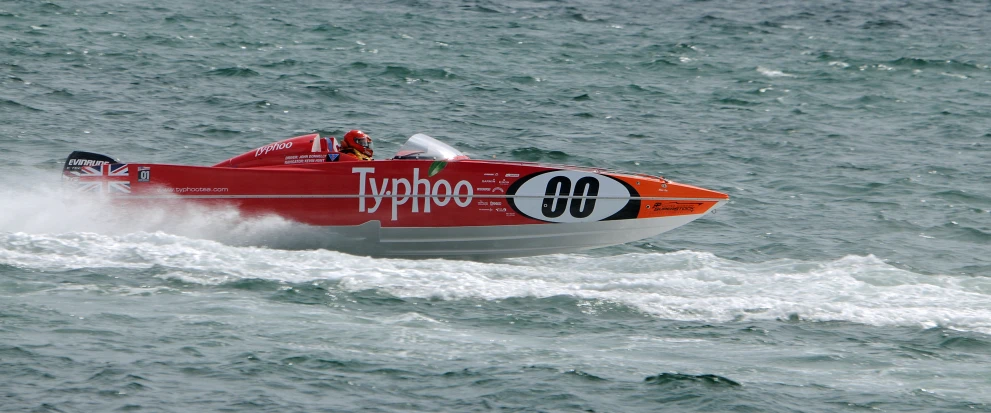 a speedboat speeds across the ocean with large waves