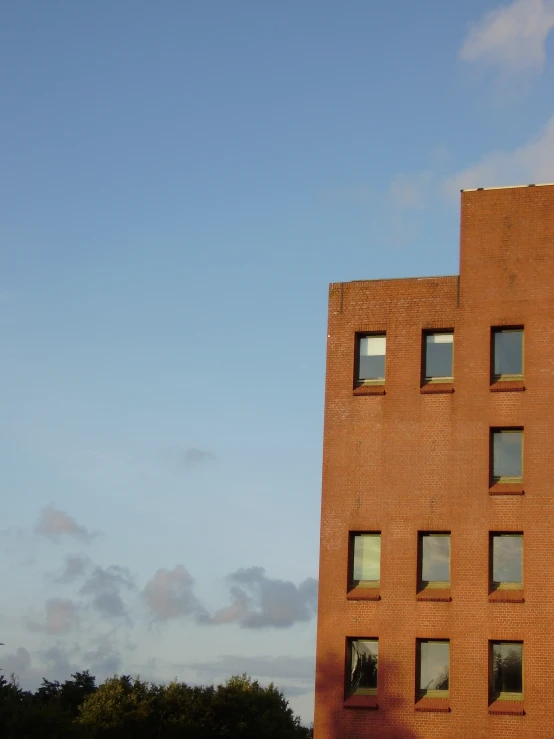 the back side of a brick building with many windows