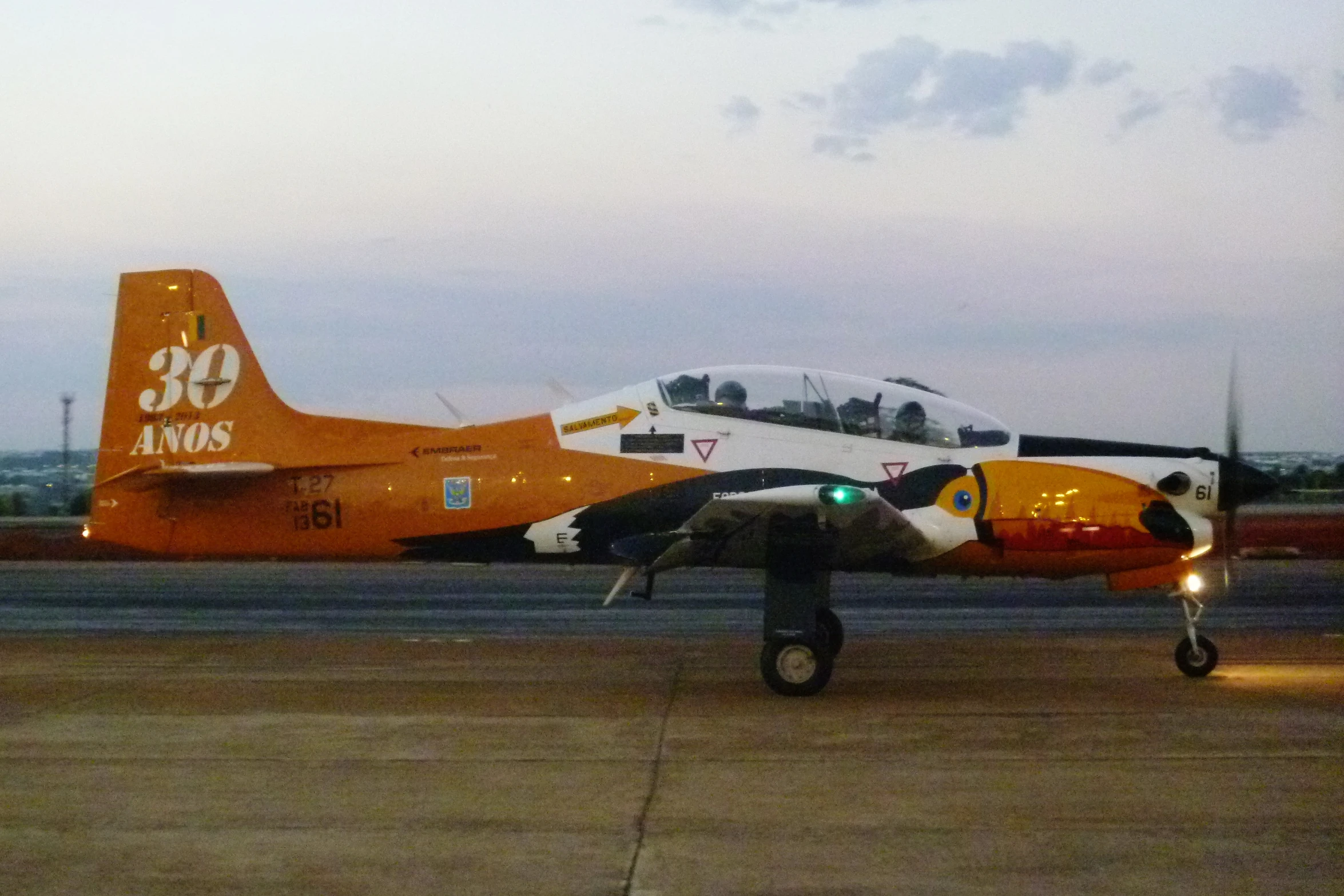 a fighter jet parked on top of an airport runway