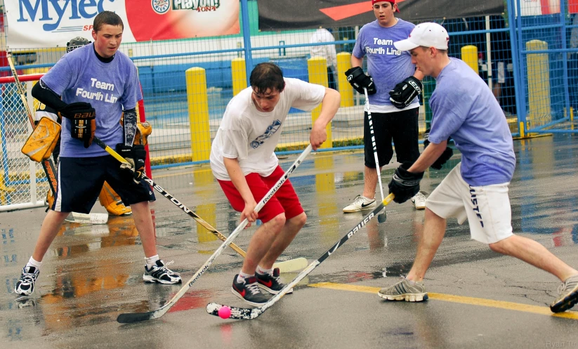 a group of men playing a game of ice hockey