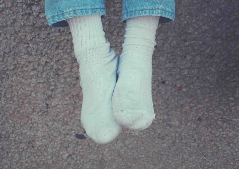 a person with white socks and socks with an orange tag