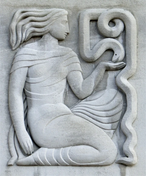 a marble decoration of a woman holding a snake