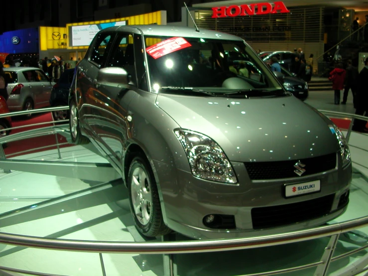 a silver car is on display at an automobile show