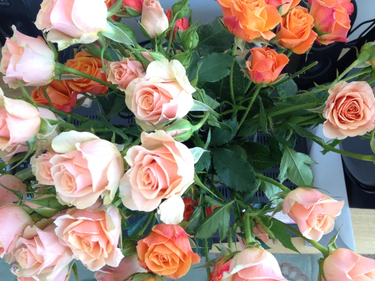 a large vase with some pretty roses in it