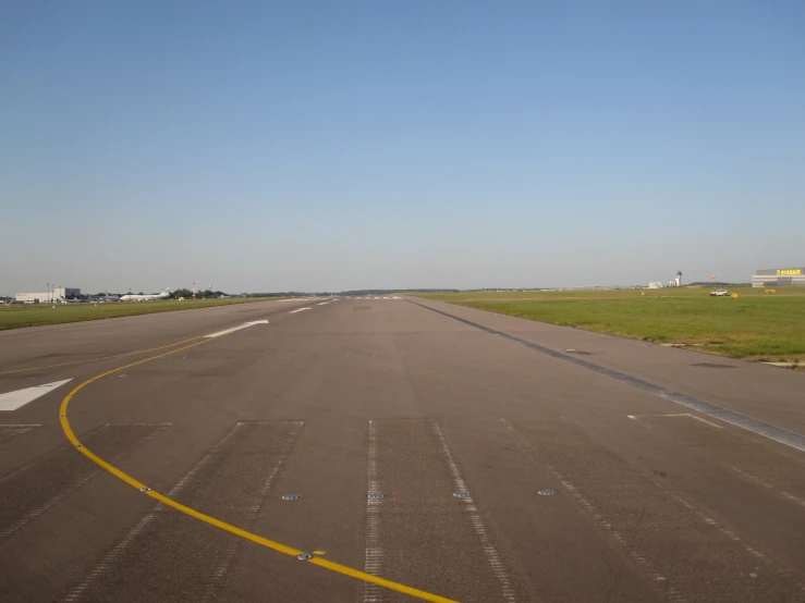 an airplane sitting on a runway in a vast plain