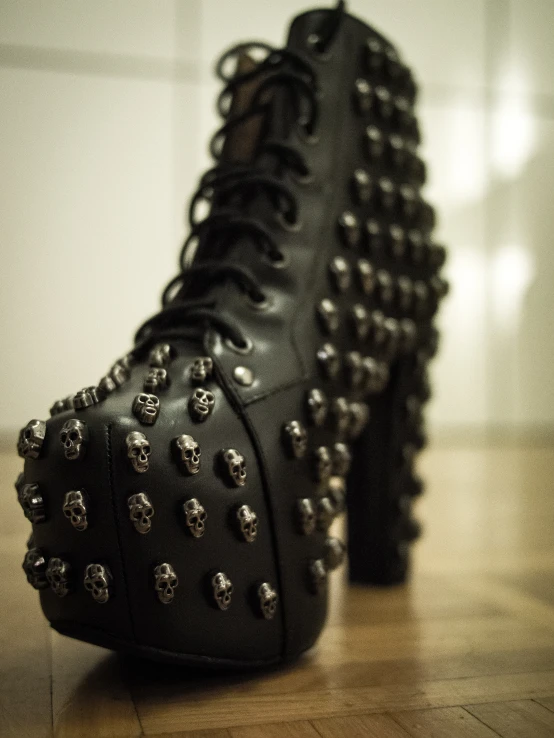 there is a pair of black shoes with metal spikes on them