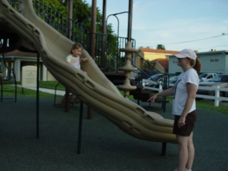 two children playing on a large play equipment