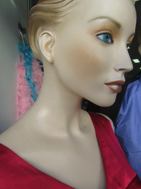 the mannequin is wearing a red dress and jewelry